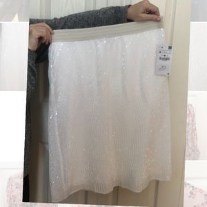 Sparkle in this white sequinned mid-length skirt!